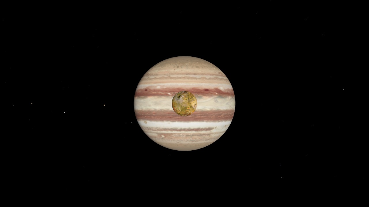 Jupiter with two of its Galilean moons, lit from the side