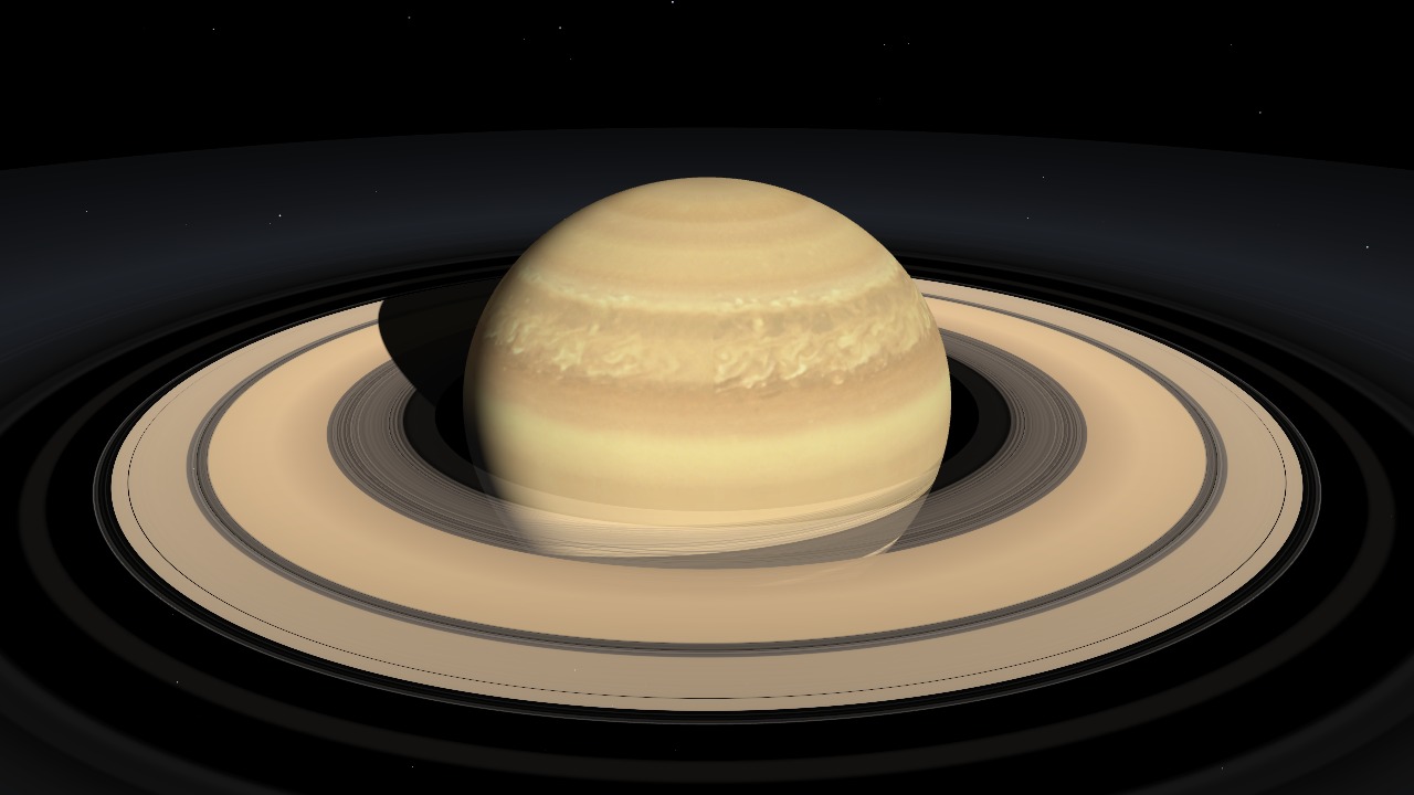 Saturn and its rings, lit from the side