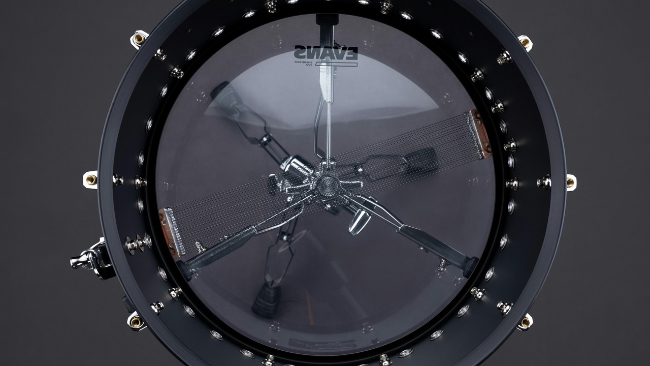 Large segmented telescope mirror inside a dome showing adaptive optics equipment