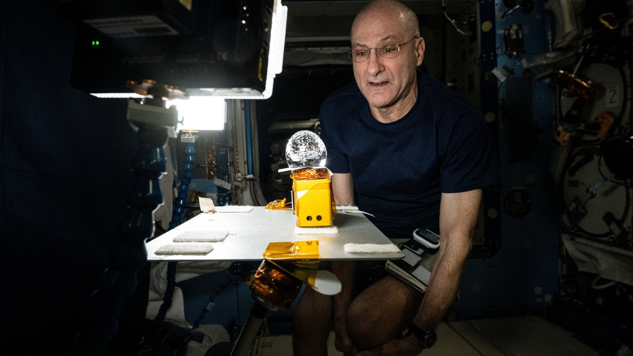 Scientists conducting experiments in microgravity aboard a commercial habitat.