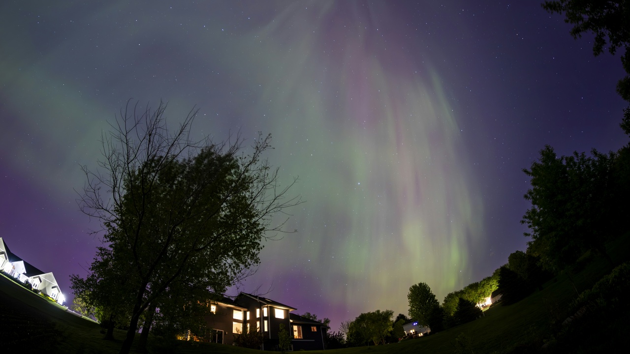 A small group at a star party using binoculars and a modest telescope to observe the night sky.