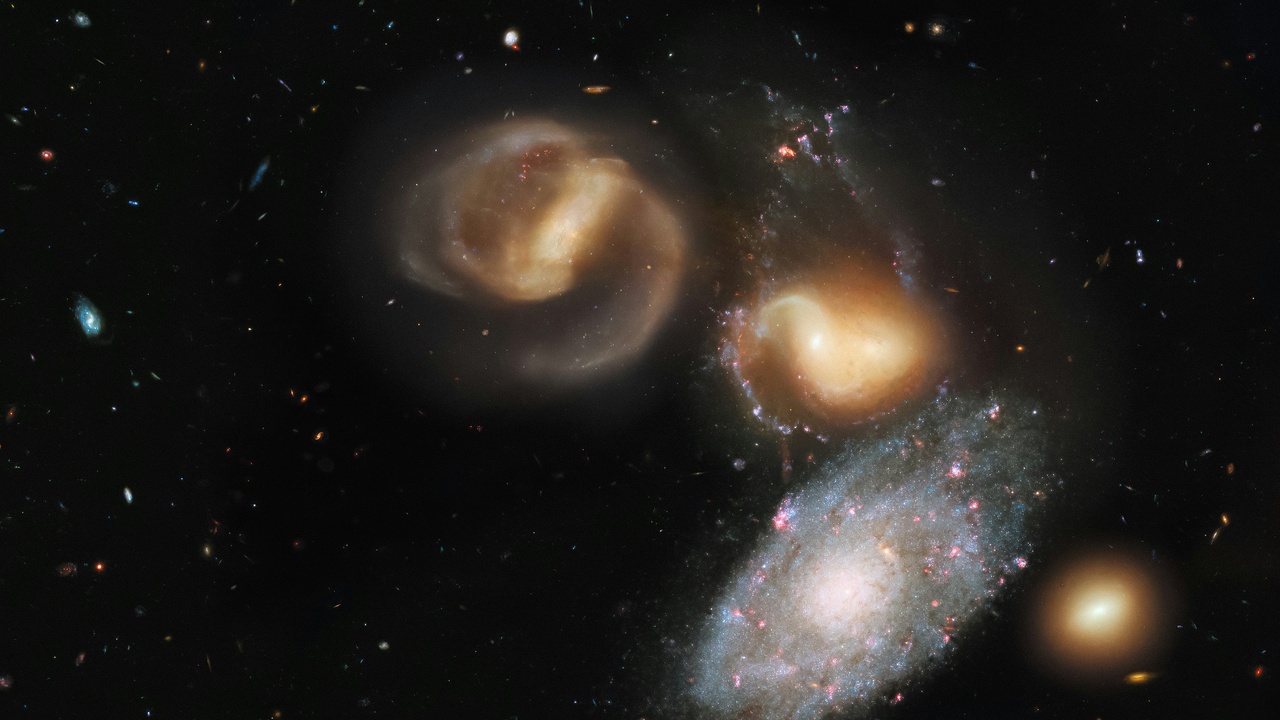 Interacting galaxies such as the Antennae showing tidal tails and starbursts