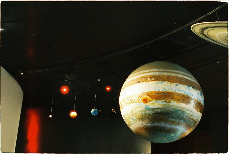 A model of the solar system with planets is on display at a science museum.