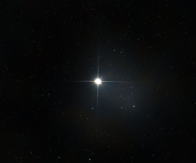 A bright star shines among countless stars in the vast, dark night sky.