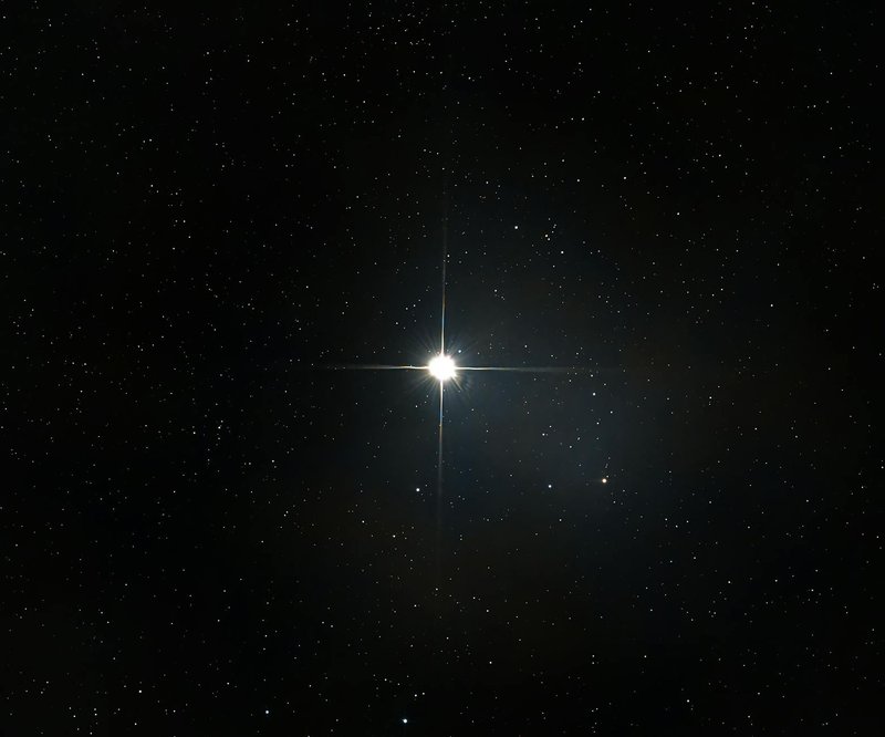 A bright star shines among countless stars in the vast, dark night sky.