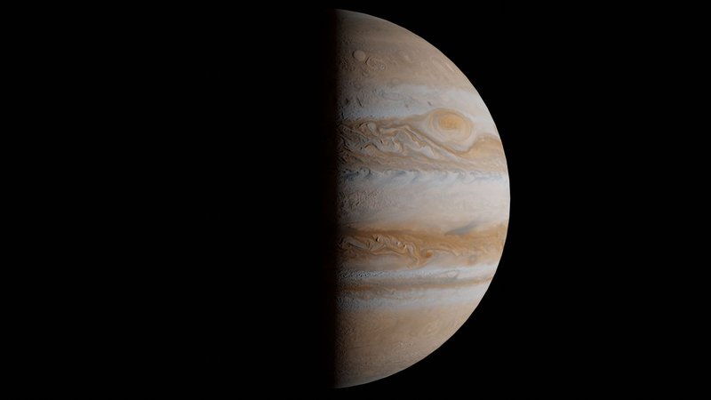Stunning half view of Jupiter with vibrant gas clouds, captured in space.