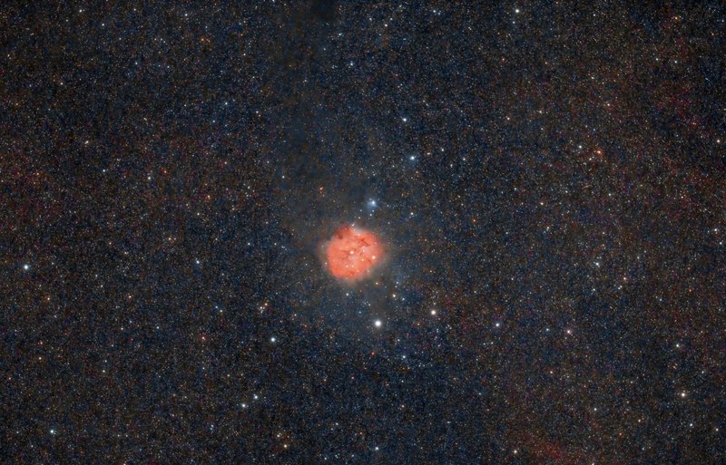 A vivid depiction of a nebula surrounded by countless stars in the vastness of space.