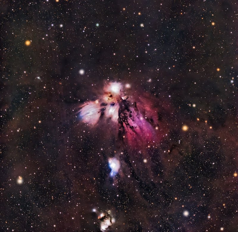 A vibrant star field with a colorful nebula captured in space's vastness.