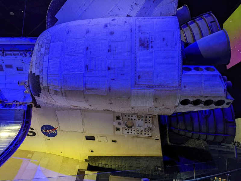 Detailed view of Space Shuttle Atlantis, showcasing engines and NASA logo at a museum exhibit.
