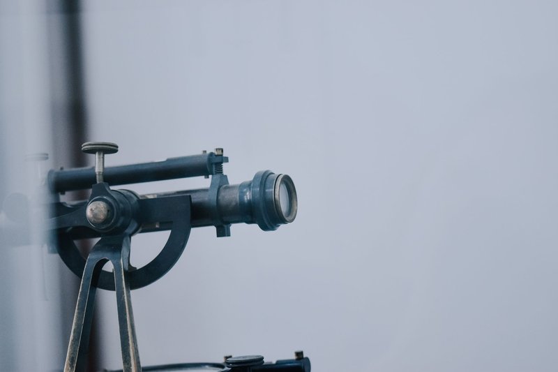 A close-up view of a vintage telescope lens showcasing intricate details and metal components.